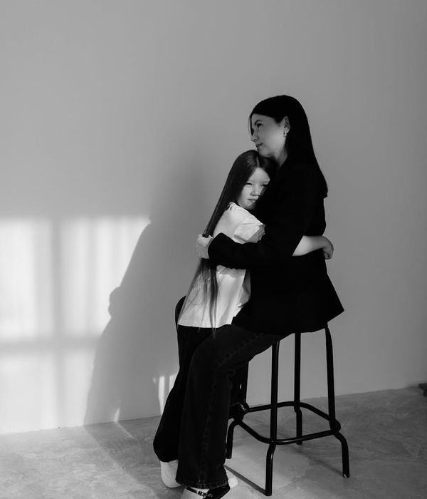 Woman in a peaceful yoga pose, bathed in warm, soft light.